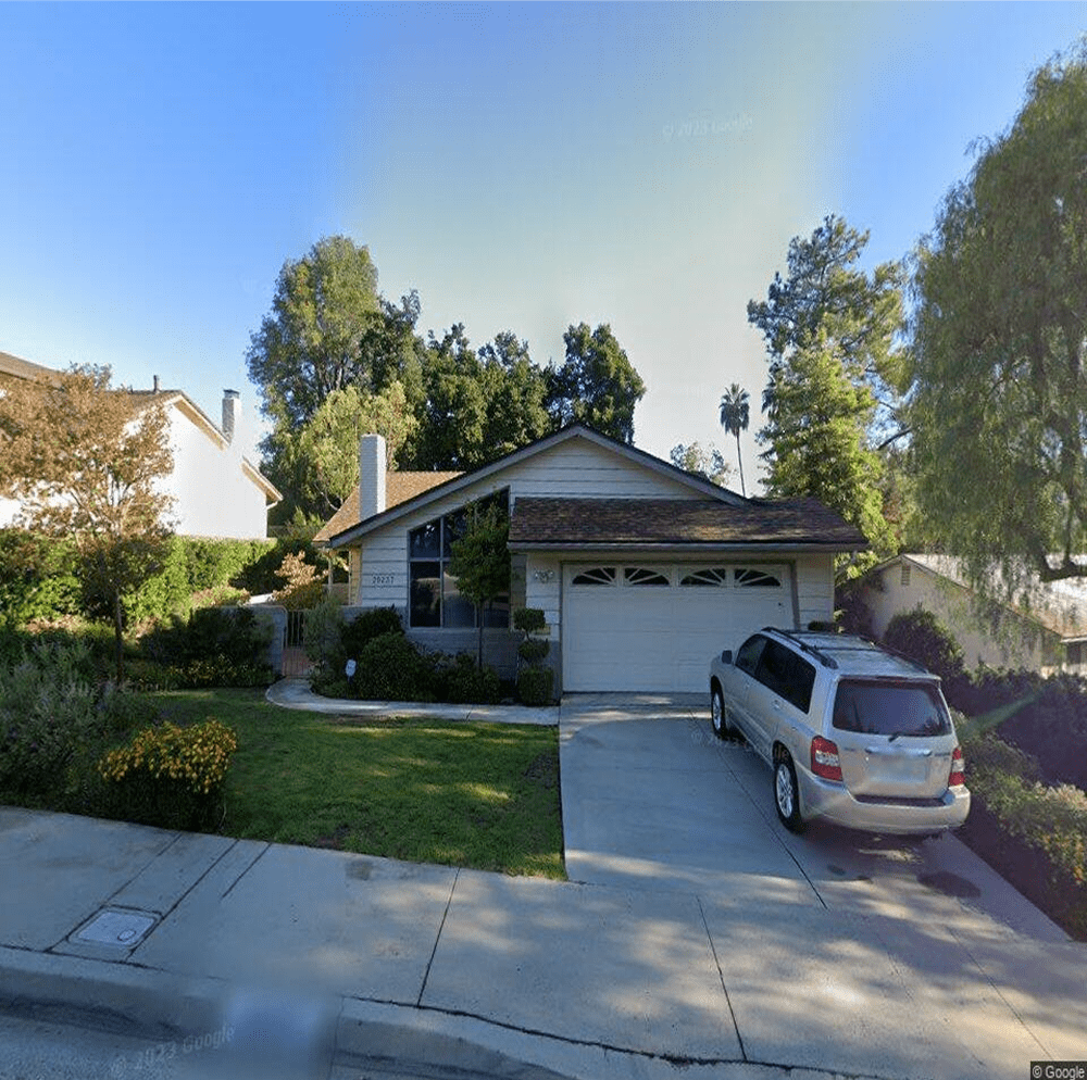 Single-story home with garage and trees